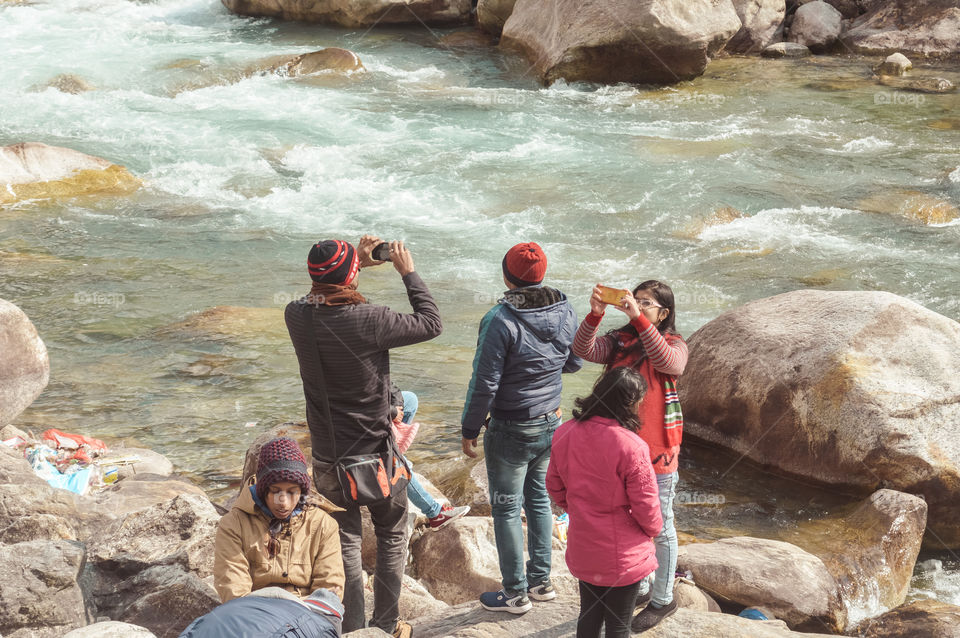 Teesta River front, Yumthang Valley, January 1 2019: Tourist people taking selfie too close to River after a recent news that group of teenager have drowned in river for photography amusement purposes
