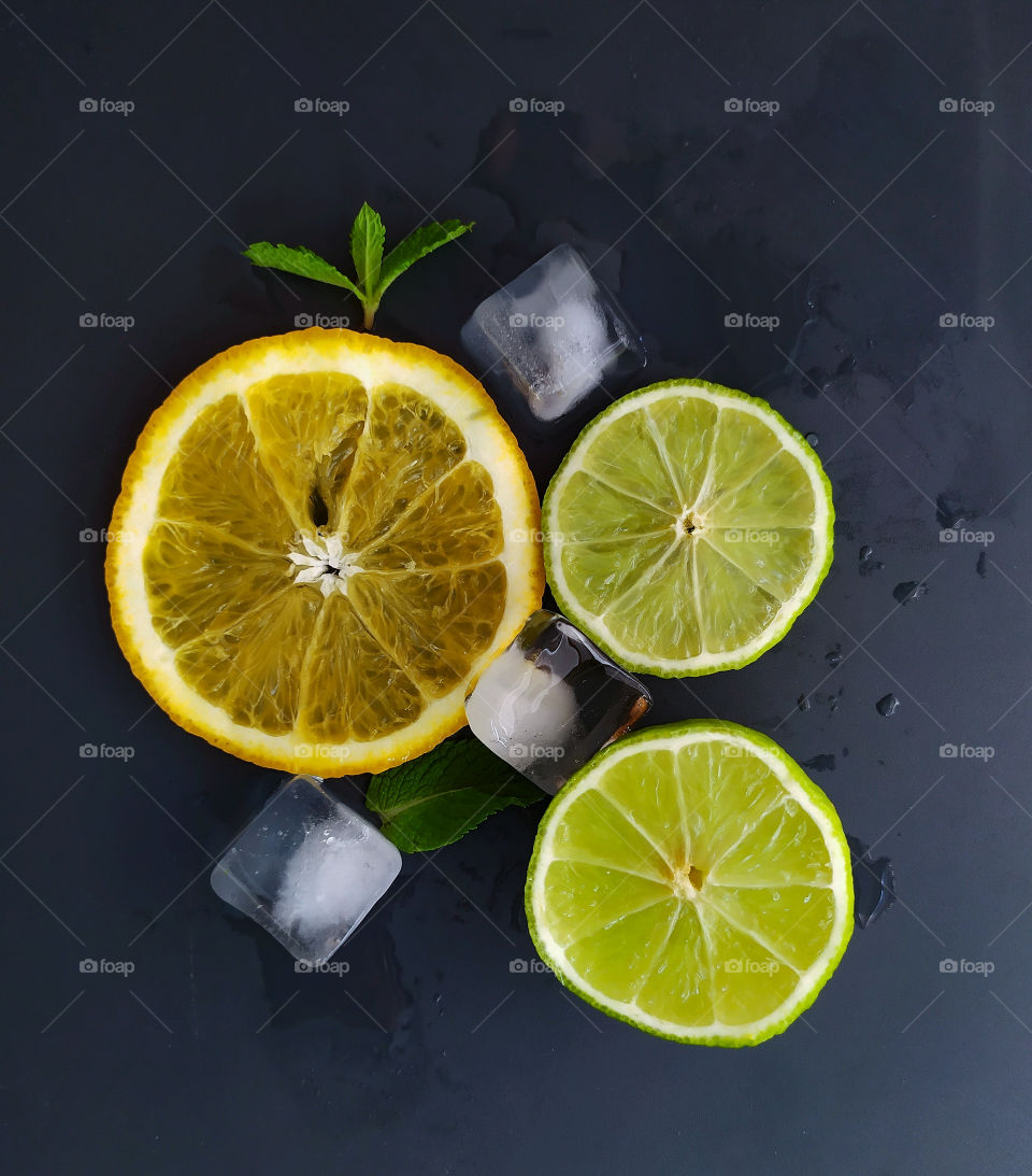 Slices of orange and lime with mint leaves and ice