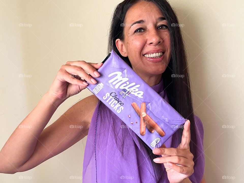 Energetic, Light-Hearted Portrait of Beautiful Smiling Woman with Milka Chocolate Sticks