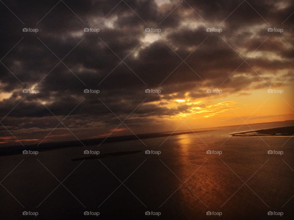 Storm clouds during sunset over sea