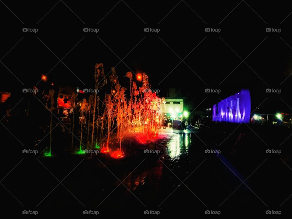 Water fountain in town square really beautiful with colour lightning from the lamp.