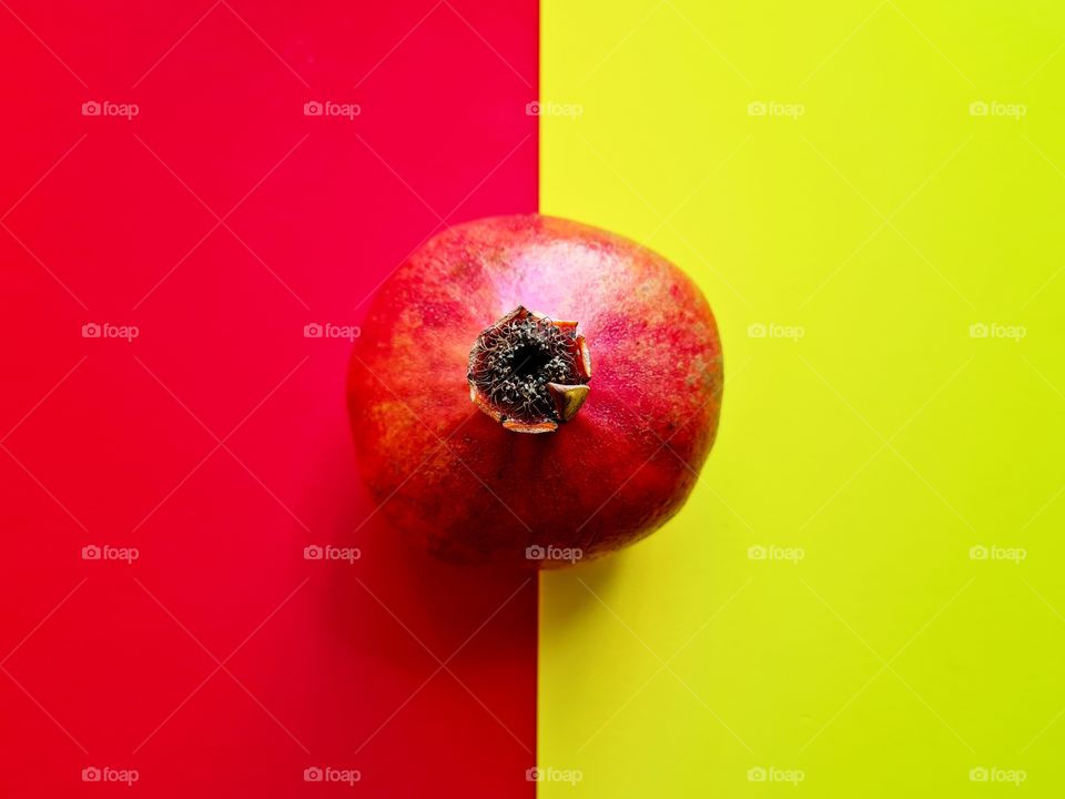 pomegranate on contrasting background of red and yellow colors