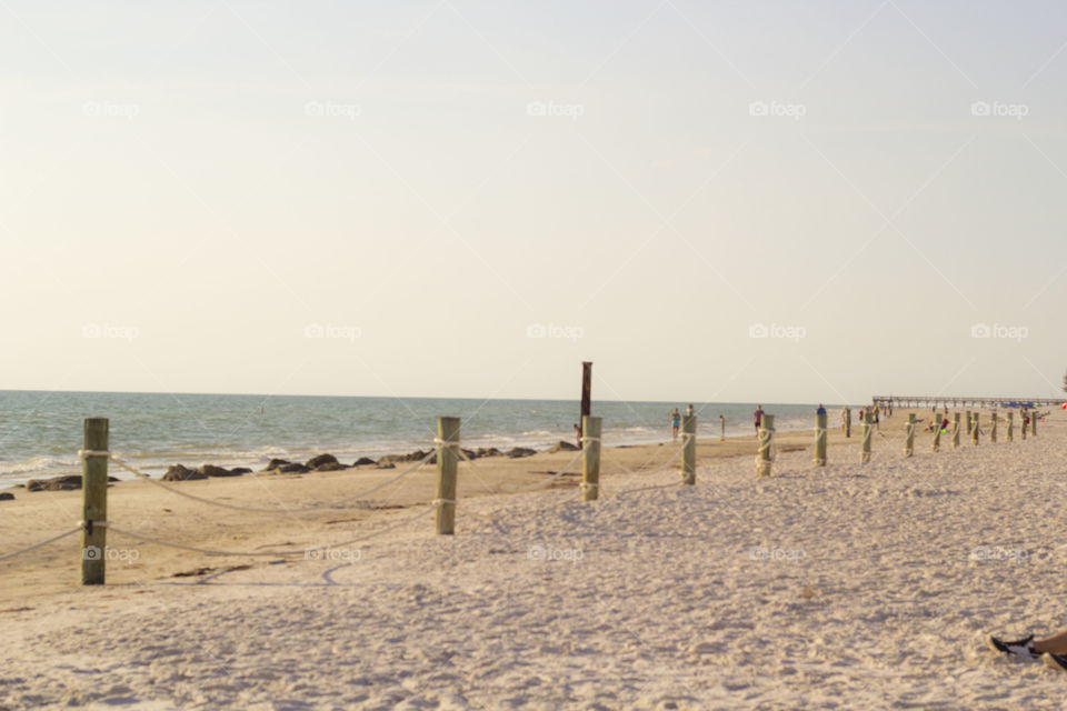 at the beach. fence posts at the beach