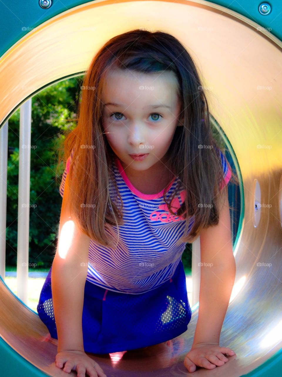 Surprise Dream. Little girl seemingly glowing outside on a playground. 