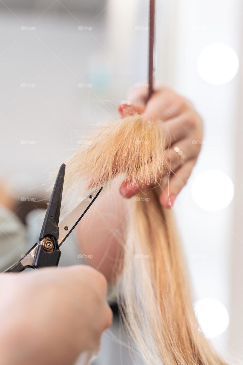 hairdresser's hands with scissors closeup