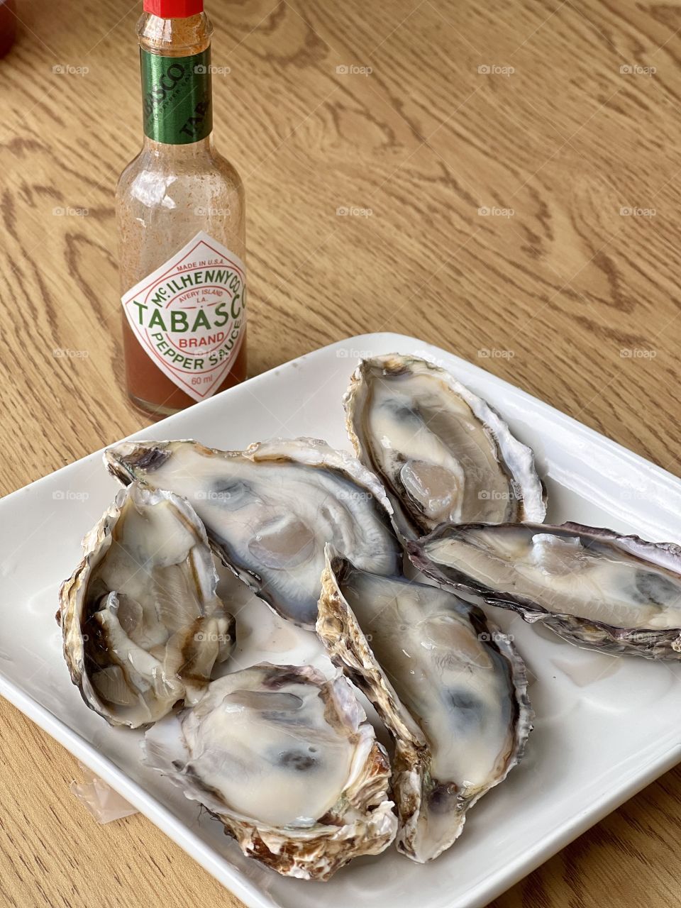 Half a dozen Freshly shucked Japanese oysters with tobacco sauce 