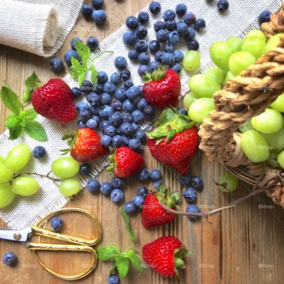 Colorful fruit flat lay with strawberries, blueberries, and grapes!