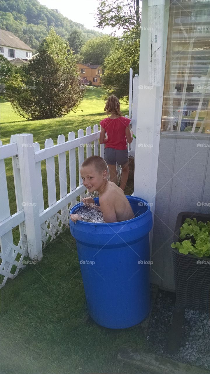 when you don't have a pool and it is hot, why not cool off in the rain barrel