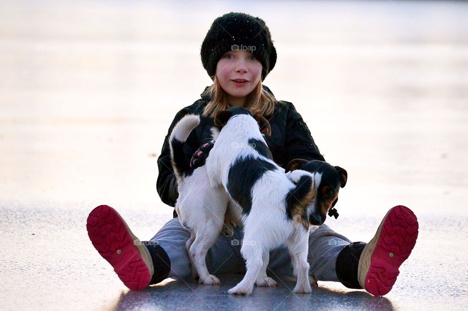 Girl playing with cute puppies