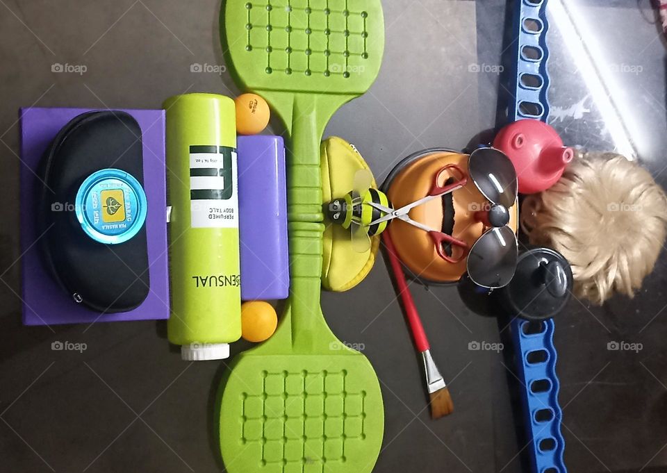 myself  trying to make an art form on my glass table using different colorful objects