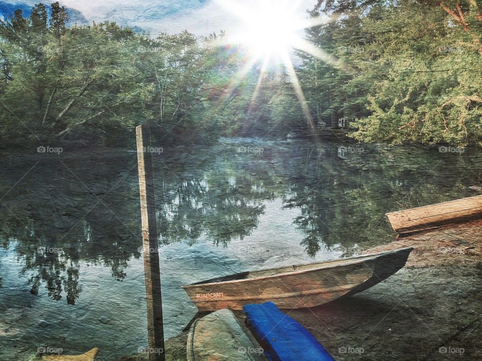 Textured lakeside with boats and kayaks