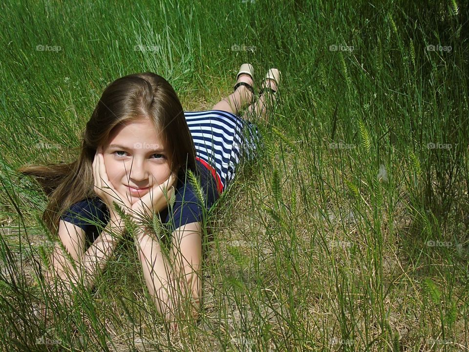 girl resting on the grass in the park, fun