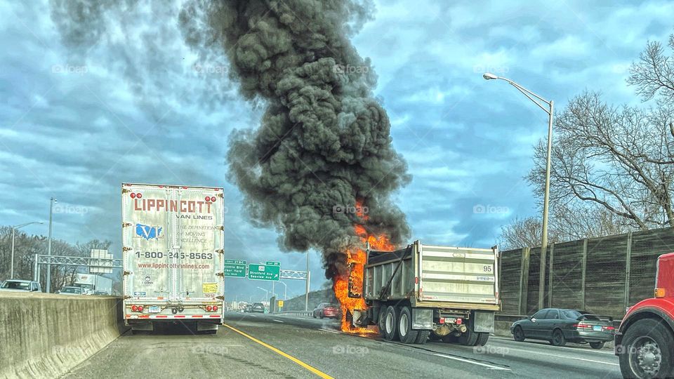 A lorry on fire on a highway in New England 