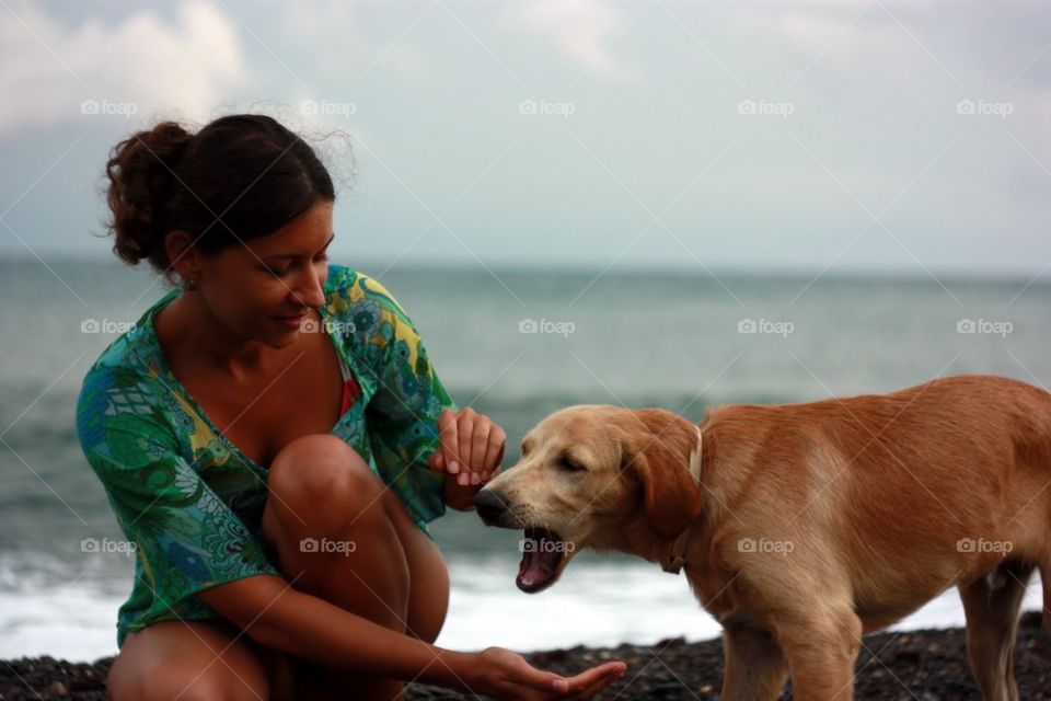 Brunette with dog at the sea 