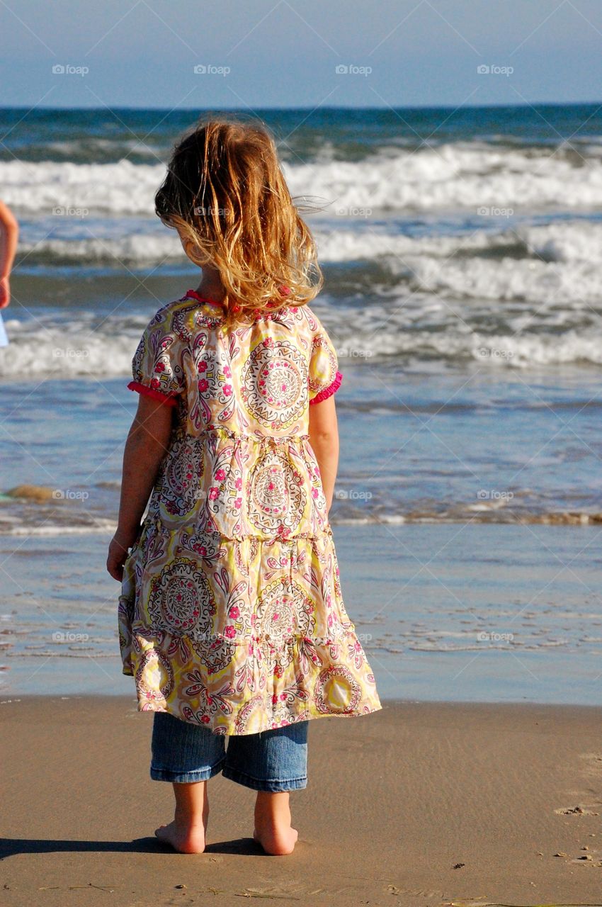 Mesmerized. The ocean surf had captured her attention