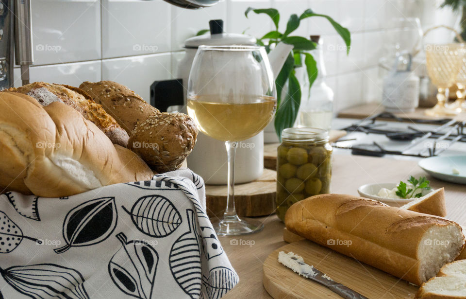 a glass of wine and bread on the table