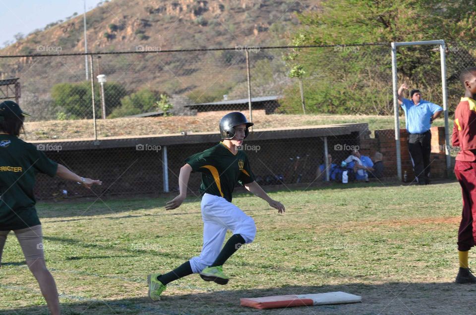 Softball player in South Africa running