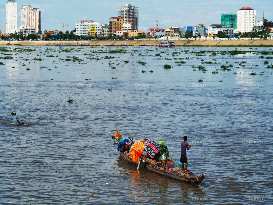 Family living on a boat on Phnom Penh riverfront 