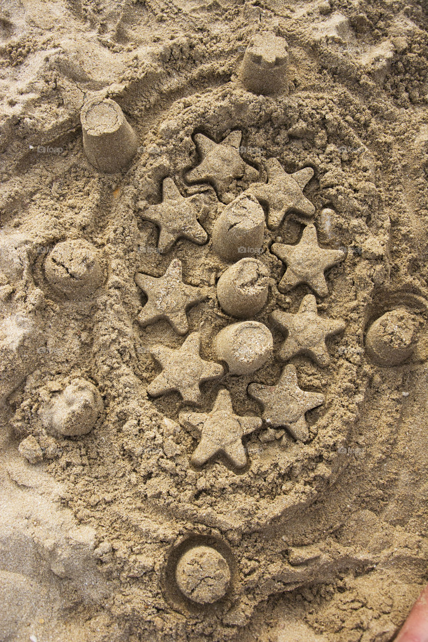 sand castle. children sand castle on beach made of stars and towers