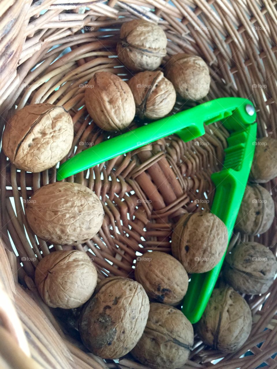 Walnuts in a basket with a nutcracker