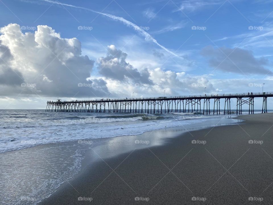 Clouds over coastal pier 