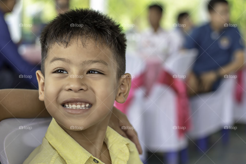 Portrait of Asian boy wisecracking and The blurry background.