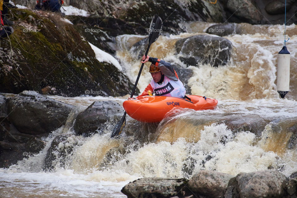 Helsinki, Finland -  April 15, 2018: Unidentified racer at the annual Icebreak 2018 whitewater kayaking competition at the Vanhankaupunginkoski rapids in Helsinki, Finland.