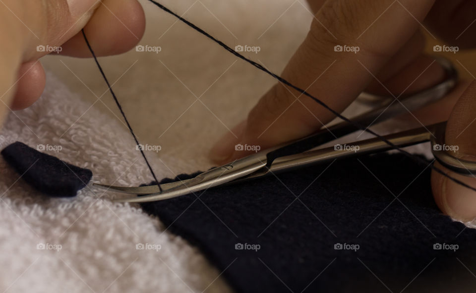 cutting a thread with scissors