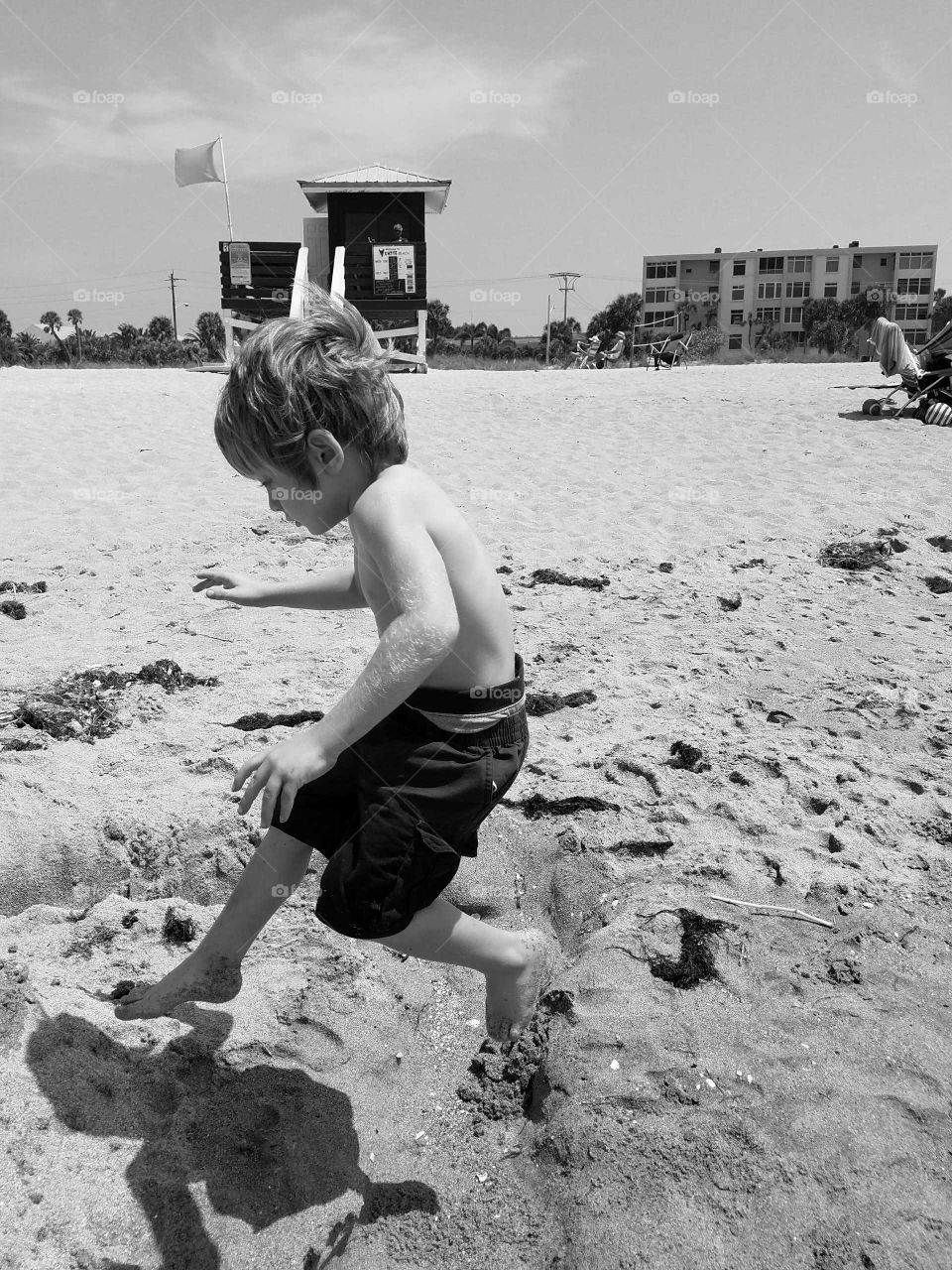 Small boy playing on sandy beach