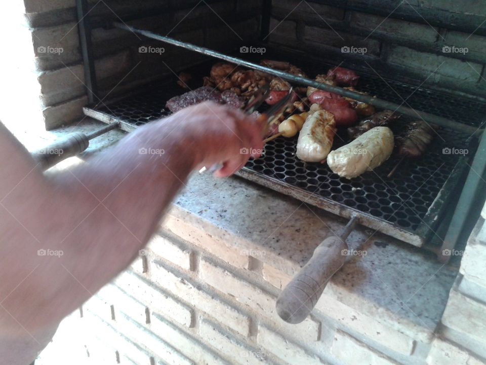 Doing a barbecue with various meats