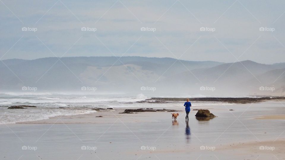 Woman and dog on the beach