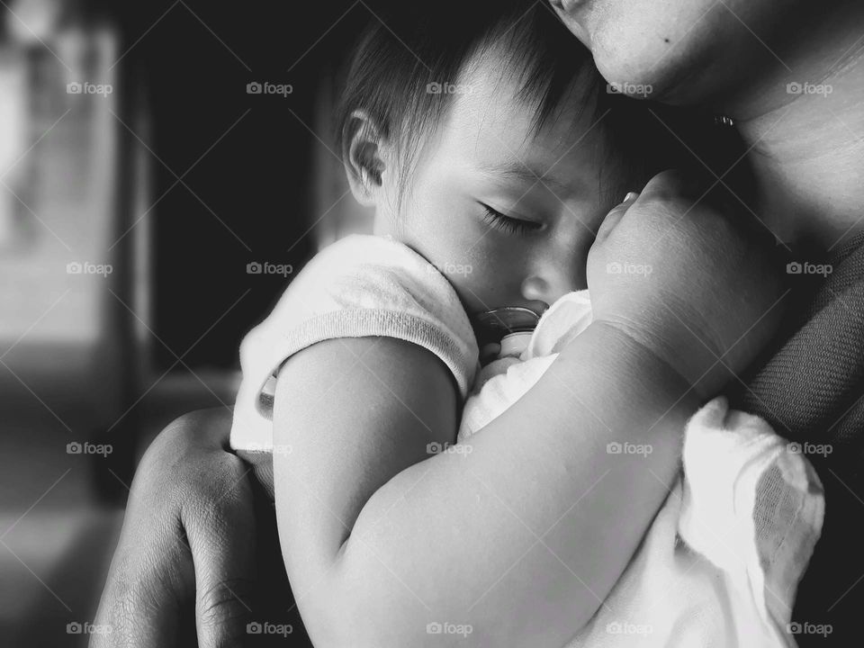 It is not about the colours but the emotions, an infant feeling safe and comfortable in the arms of her mother.