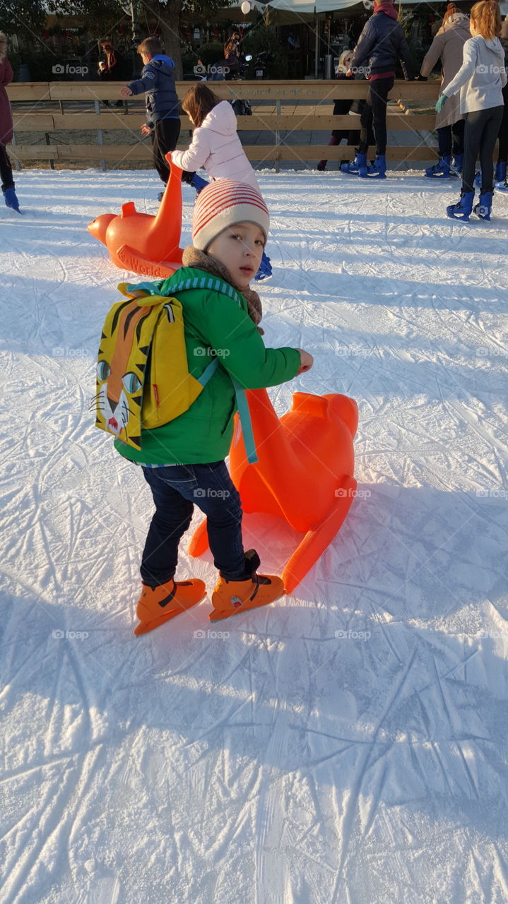 Boy playing with toy in snowpark