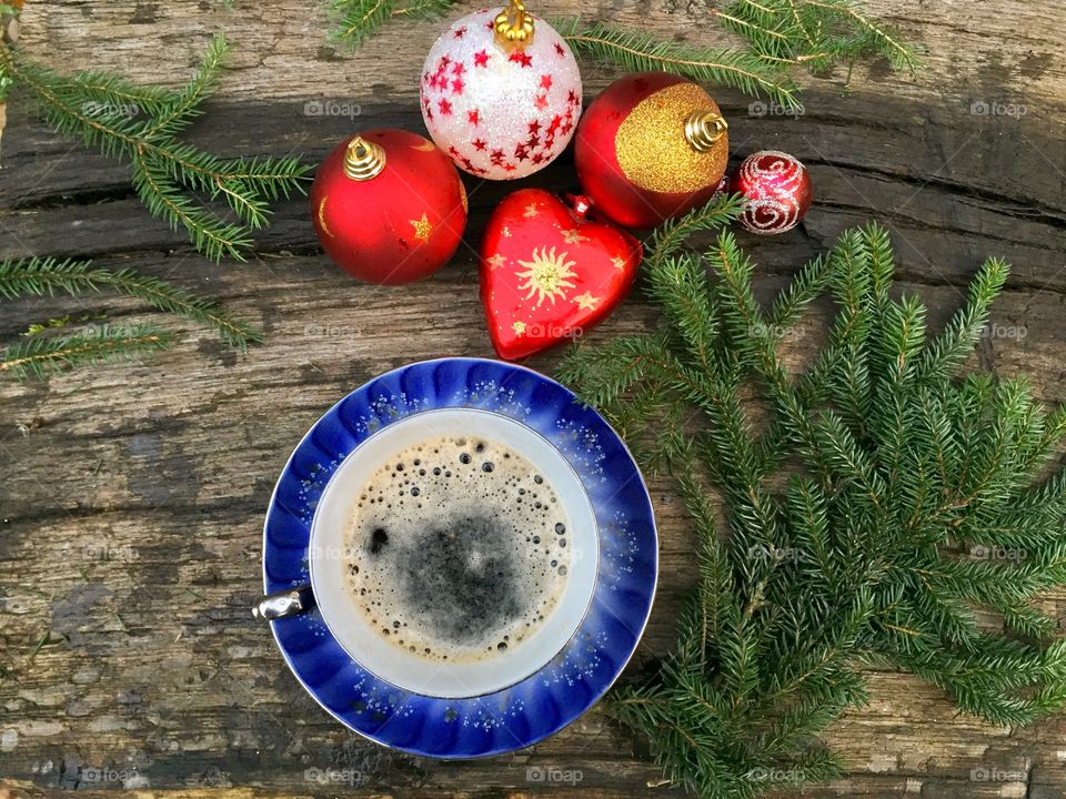Christmas ornaments and coffee on wooden table
