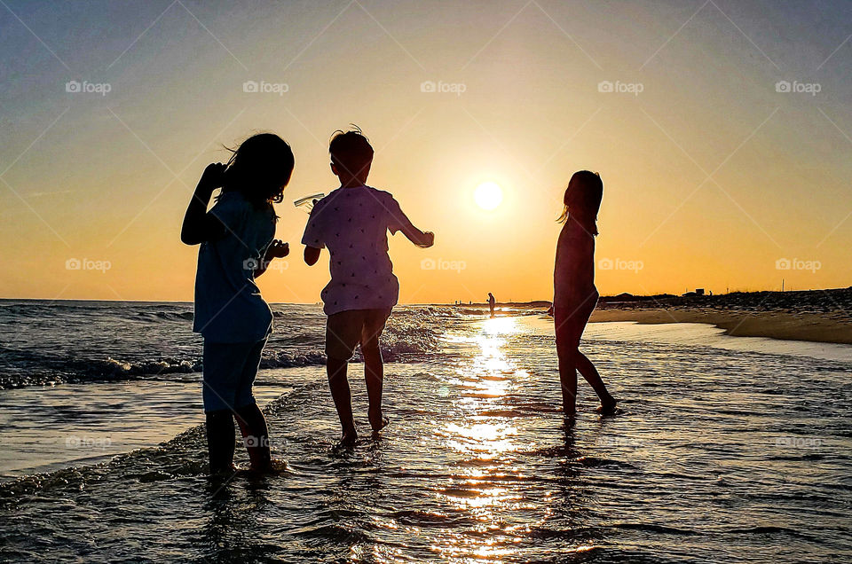 Kids having fun in the ocean.
