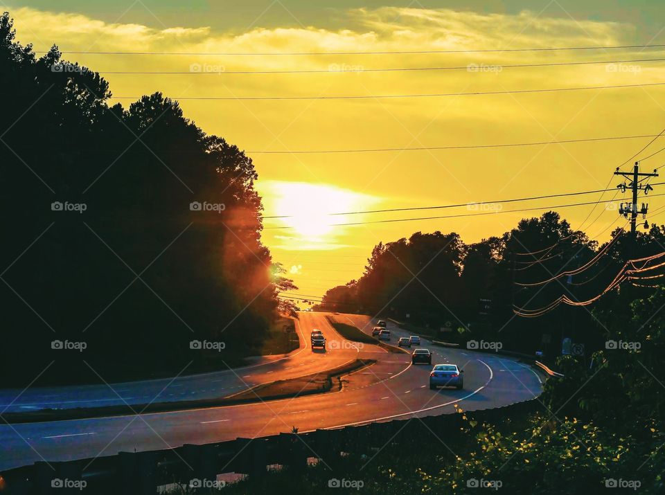 Sunset capture of a road that leads into the sunset