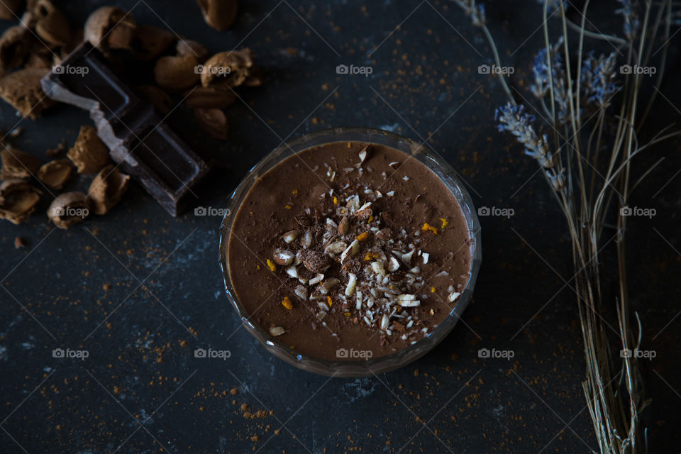 Chocolate and almond muss with orange zest. Homemade dessert on dark background.