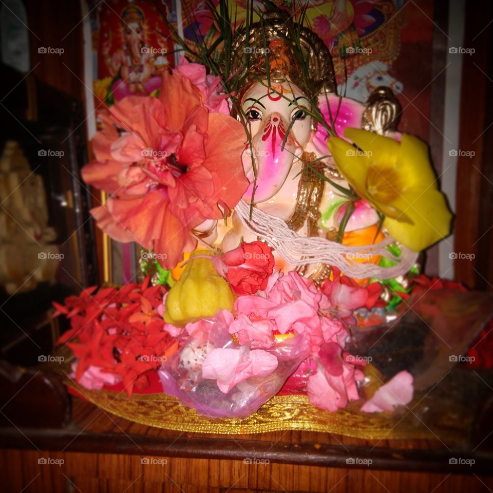 Indian festival, Indian God idol, colorful statue of God decorated with flowers and sweets