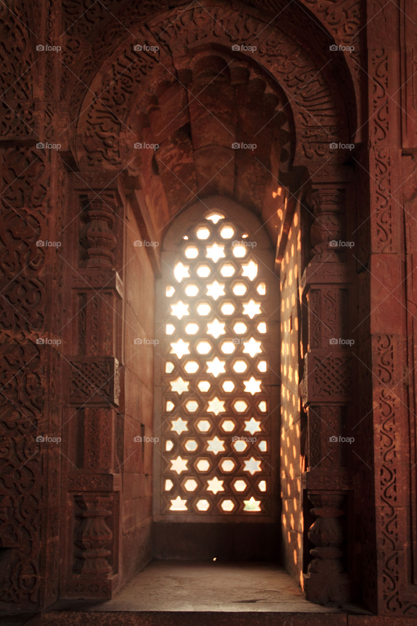 Light coming through a ornamental window in qutub Minar, New Delhi, India