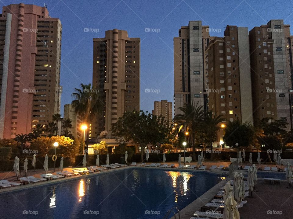 Lounge chairs by building swimming pool