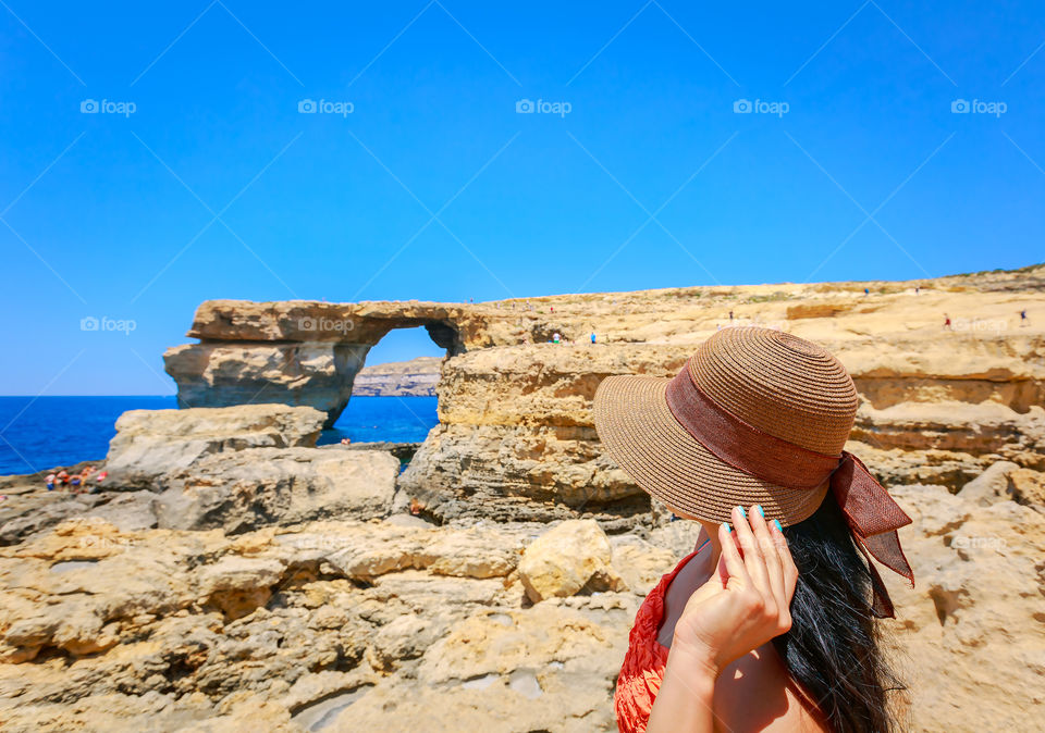 Woman wearing hat standing on beach