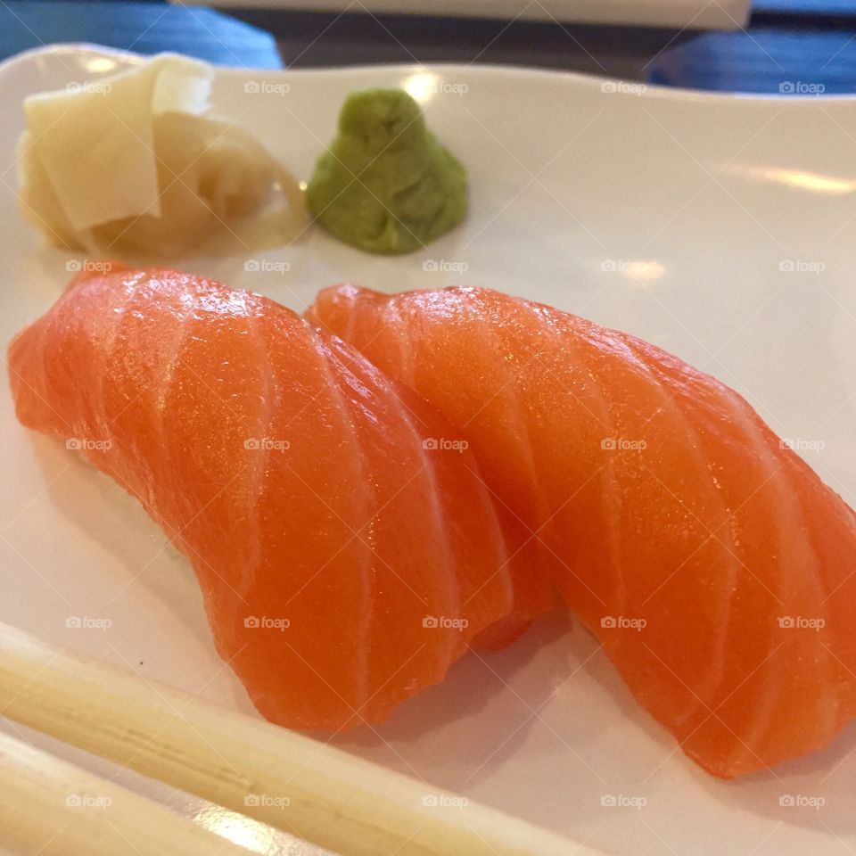 Salmon nigiri with wasabi and ginger. 