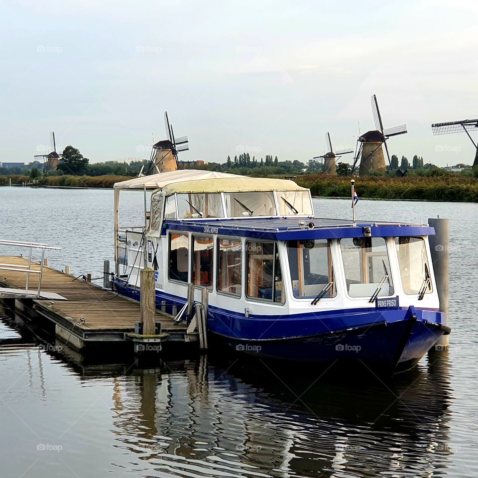 Boat along the jetty, Kinderdijk, Alblasserdam, The Netherlands.
