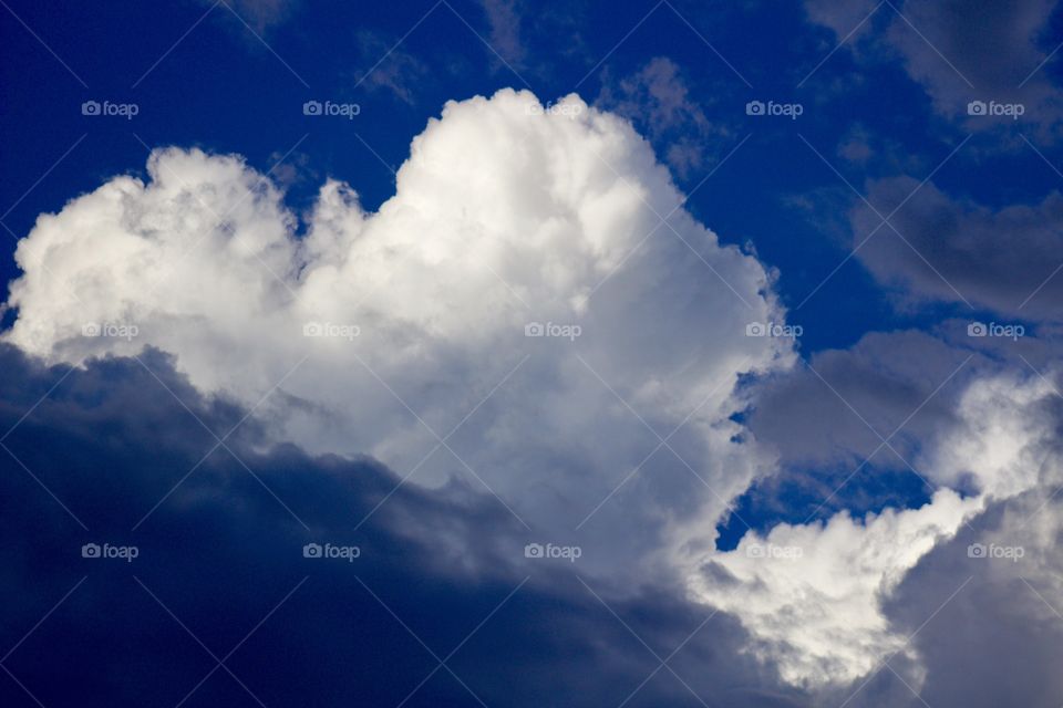 Hope of Clearing Skies - a large cumulus cloud towers over dark skies 