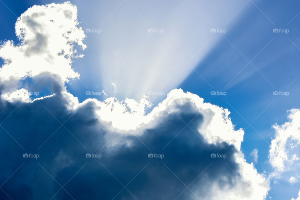 sun light rays shines over the clouds