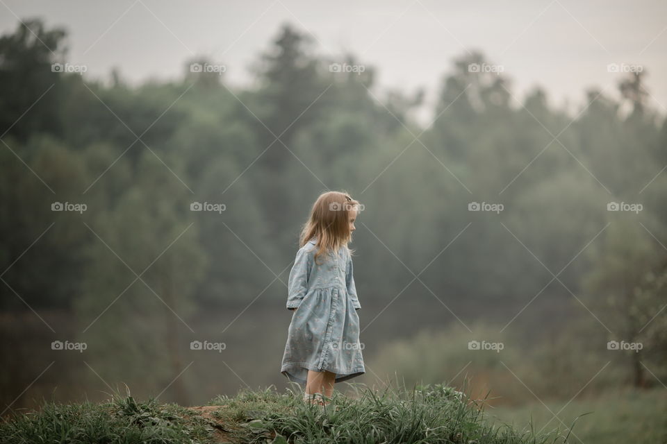 Little girl  in the summer field 