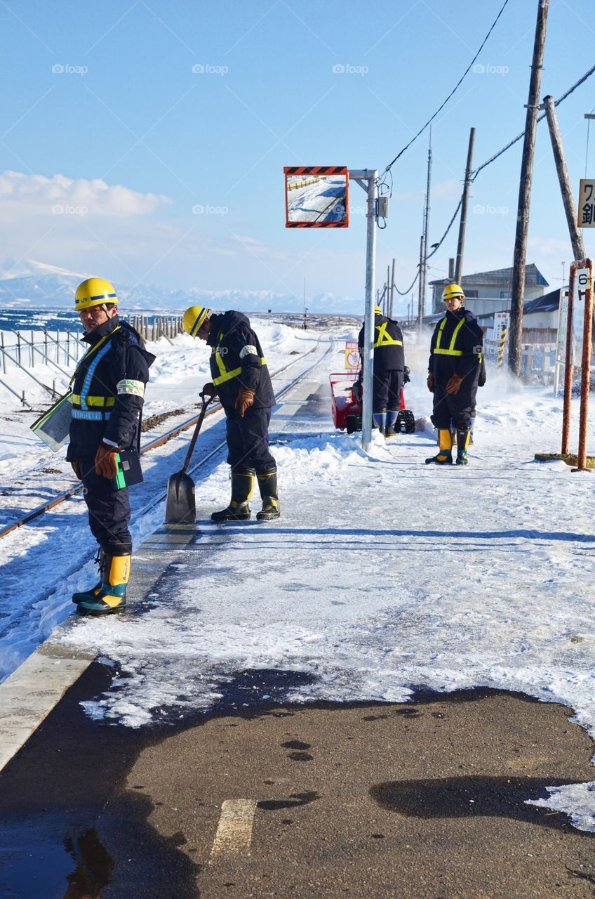 Train Station Staff Shoveling the Snow