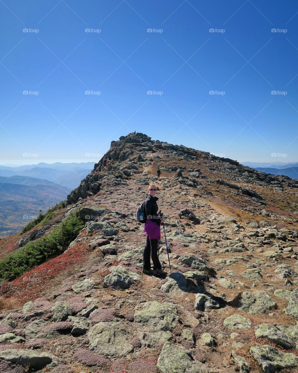 Woman hiking on  mountain top 