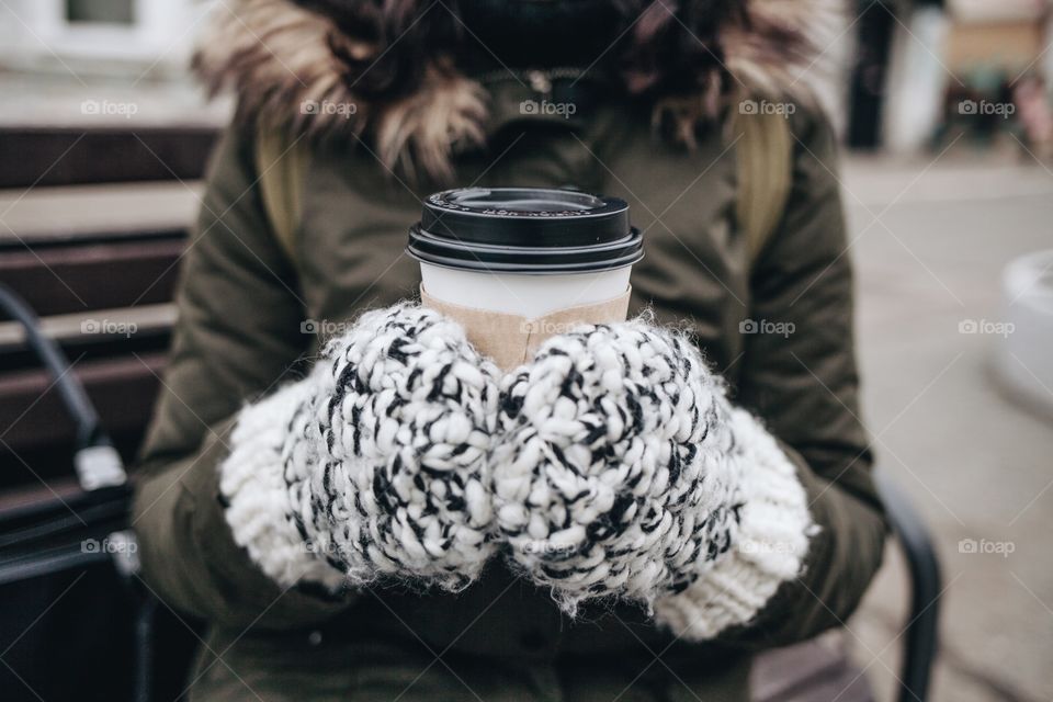 Close-up of woman's hand holding coffee cup