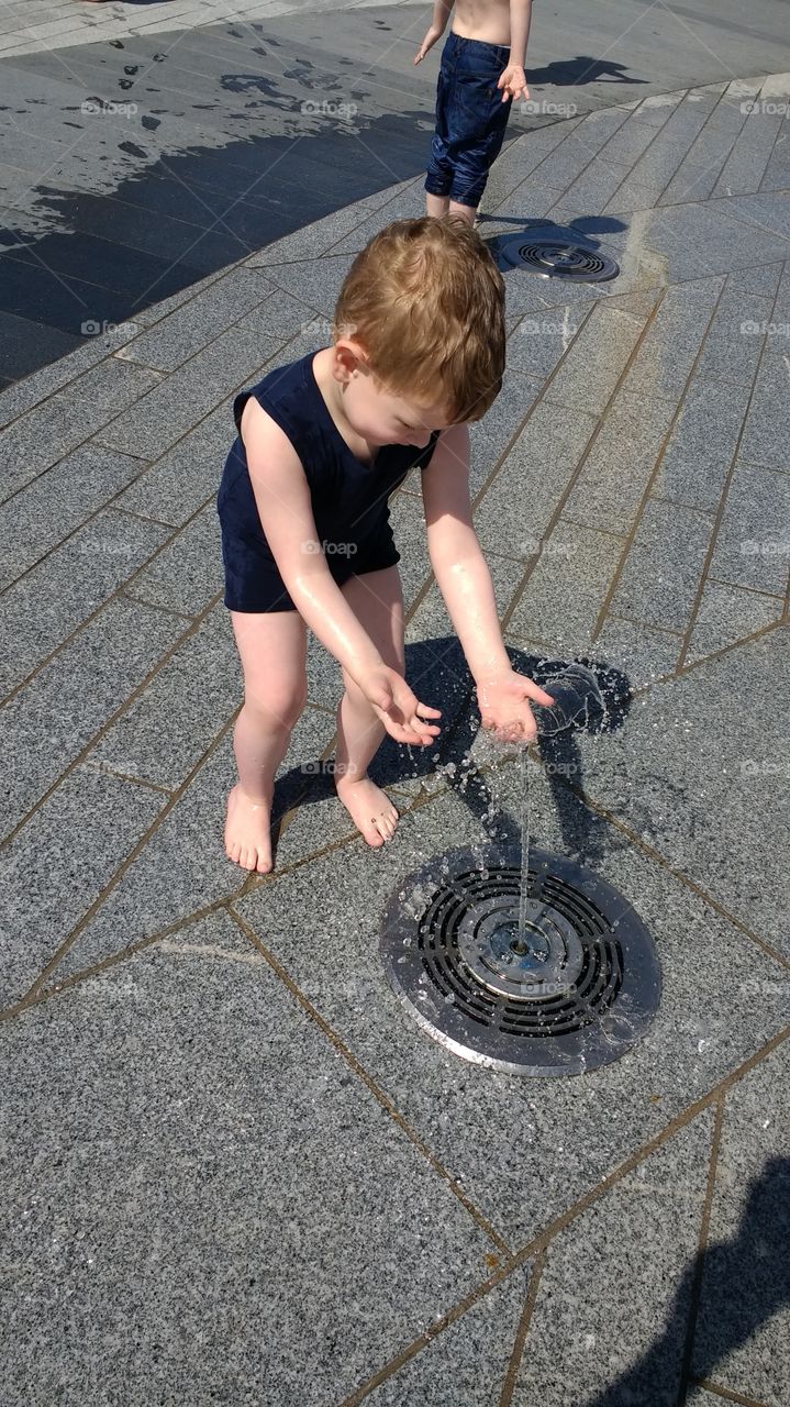 Boy plays with water